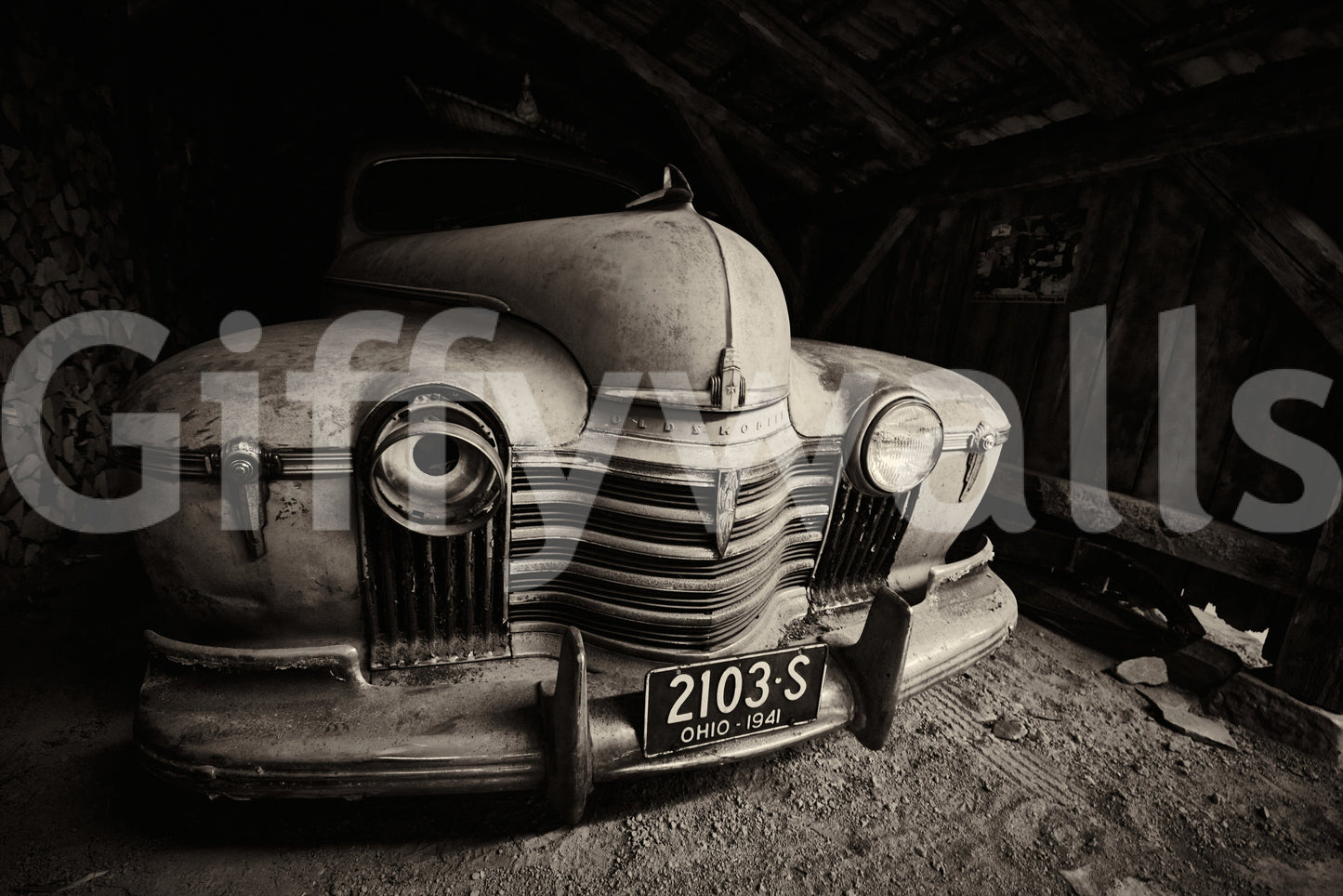 Vintage Ride: 1941 Olds wallpaper mural shown as a full wall of a dusty 1941 Oldsmobile front parked in an old barn