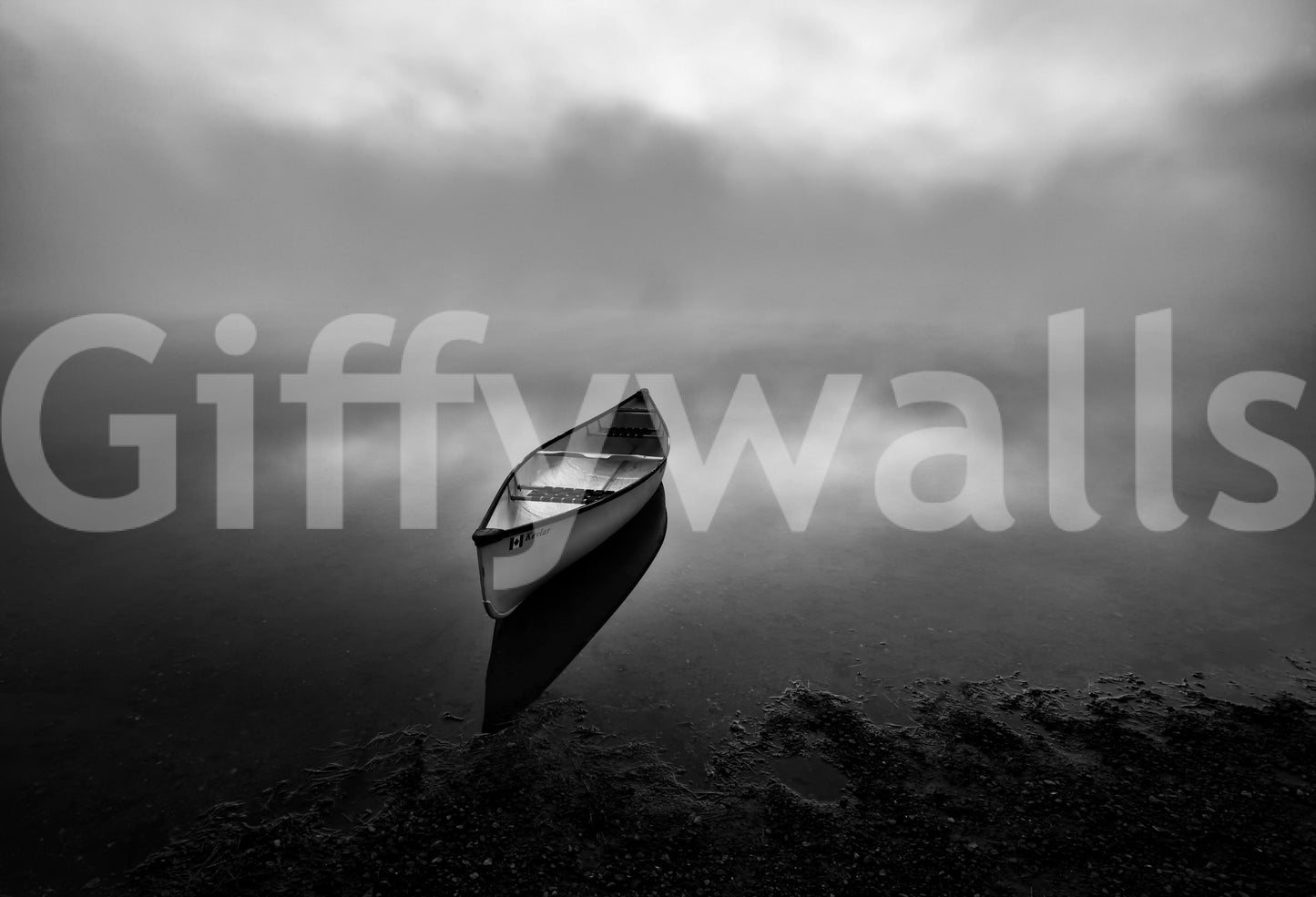 Foggy Voyage wallpaper mural close-up of a lone canoe resting on a calm misty lakeshore under a moody overcast sky