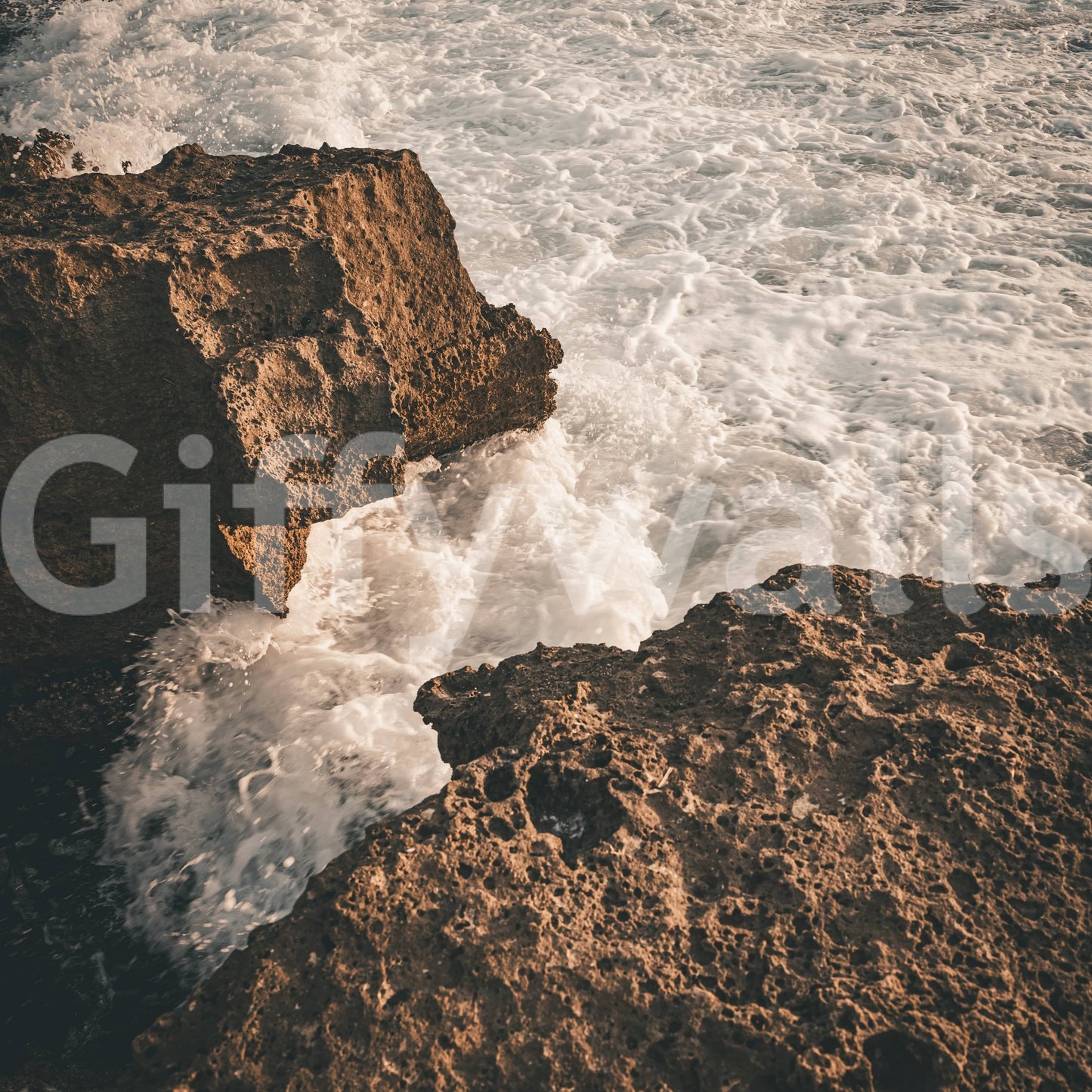 A detail of the warm tones in the rock and water.