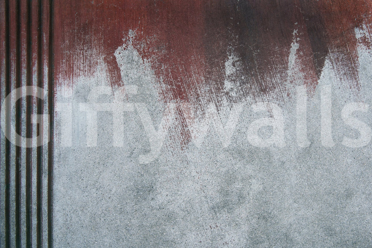 Gritty Fade wallpaper mural close-up showing a rust-red wash fading into pale grey weathered concrete