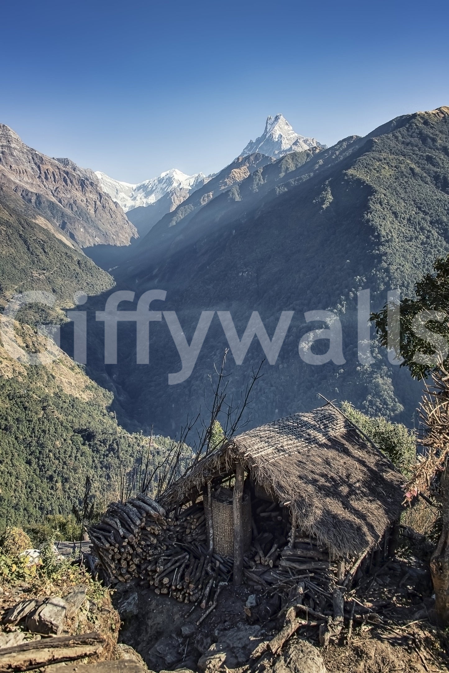 Travel-inspired wall mural featuring a remote hut and breathtaking mountainous terrain.