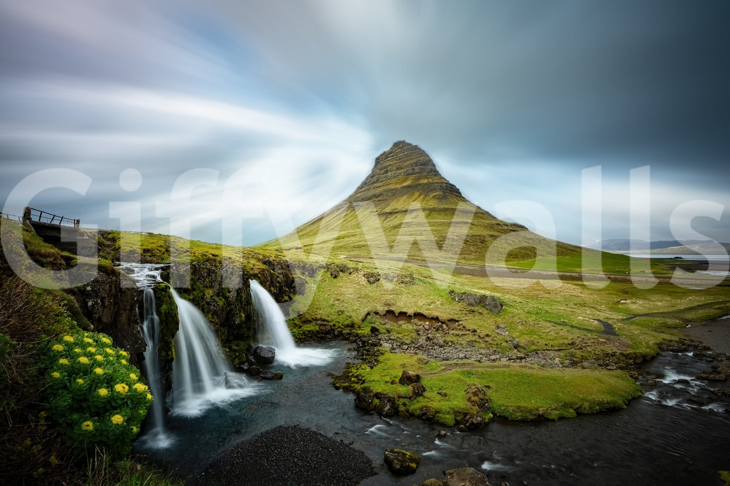 Kirkjufell Mountain Serenity wallpaper mural shown as a full-wall mural of the green peak, waterfalls and moody sky