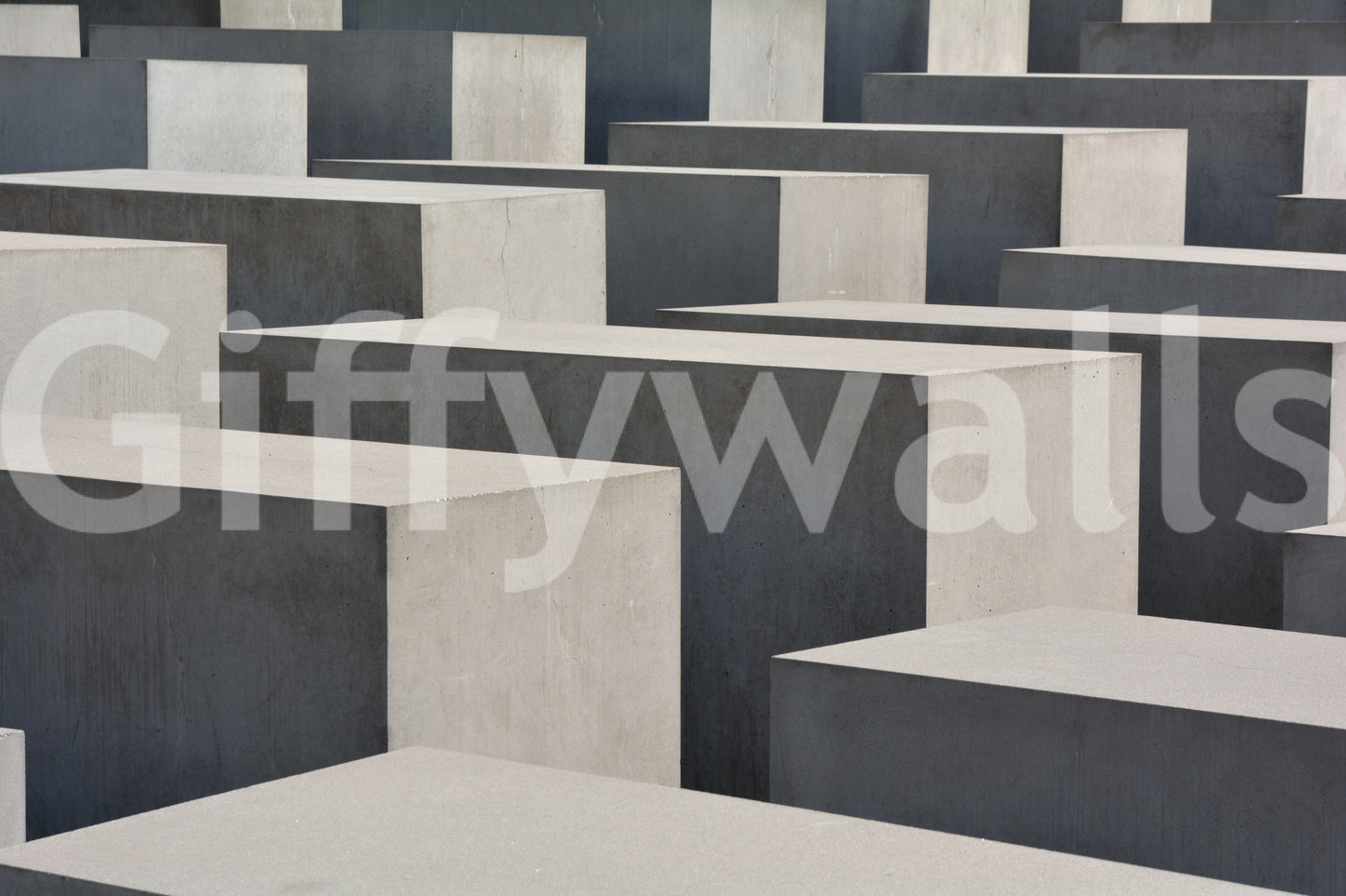 Concrete Geometry wallpaper mural shown as a full-wall close-up of grey and charcoal 3D concrete blocks