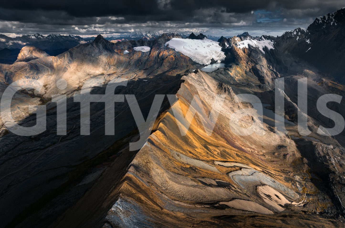 Mountain Ridge Vista wallpaper mural close-up of a golden rocky ridge with glaciers under heavy storm clouds
