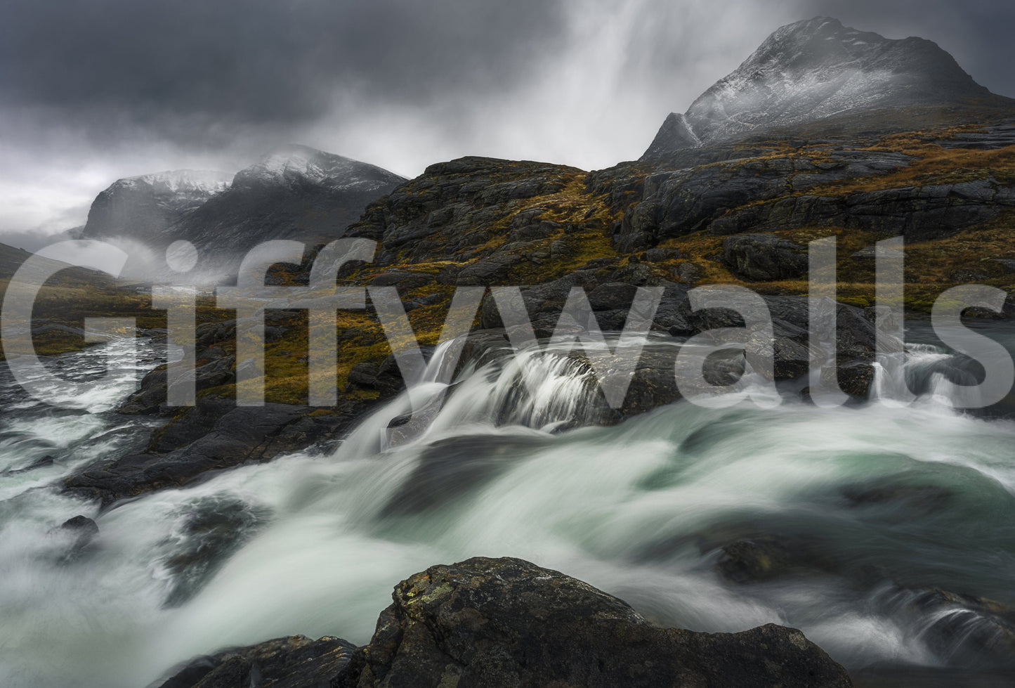 Noir Mountain Flow wallpaper mural shown as a full-wall render of a white waterfall below stormy snow-dusted peaks