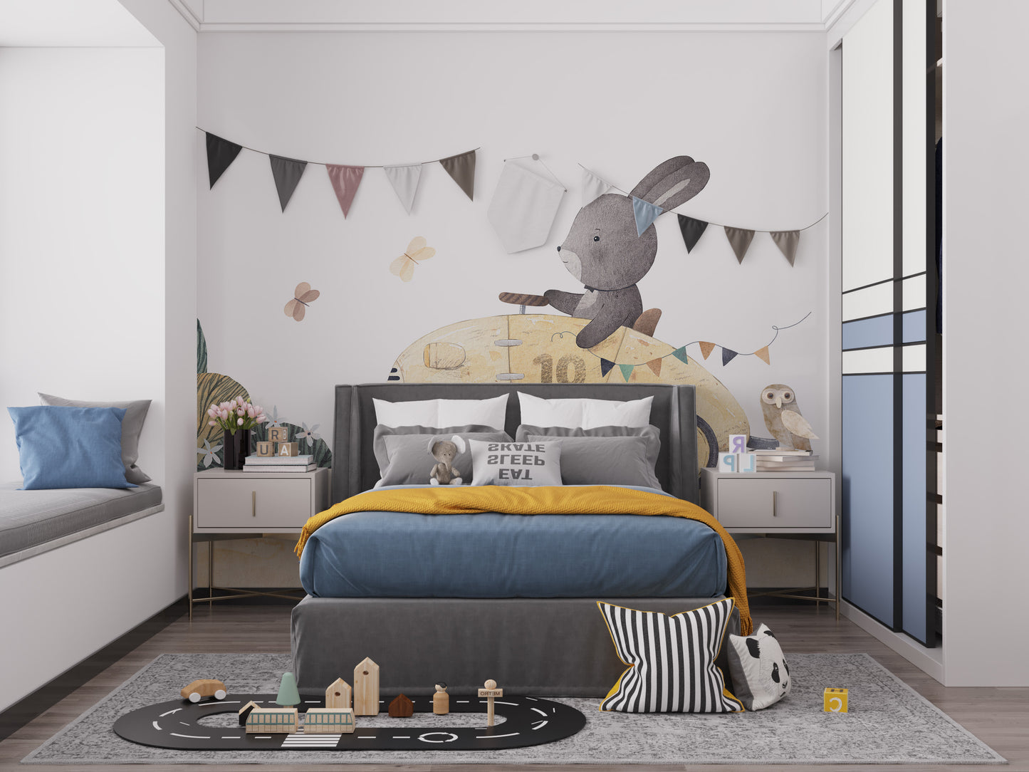 Playful Bunny Car Ride Kids wallpaper mural with bunting behind a grey bed with blue and mustard bedding