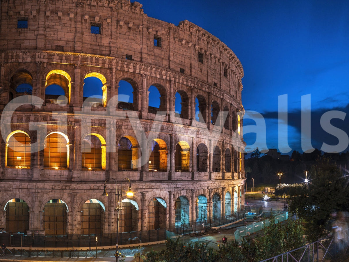 Roman Nights wallpaper mural showing the floodlit Colosseum at night against a deep blue evening sky