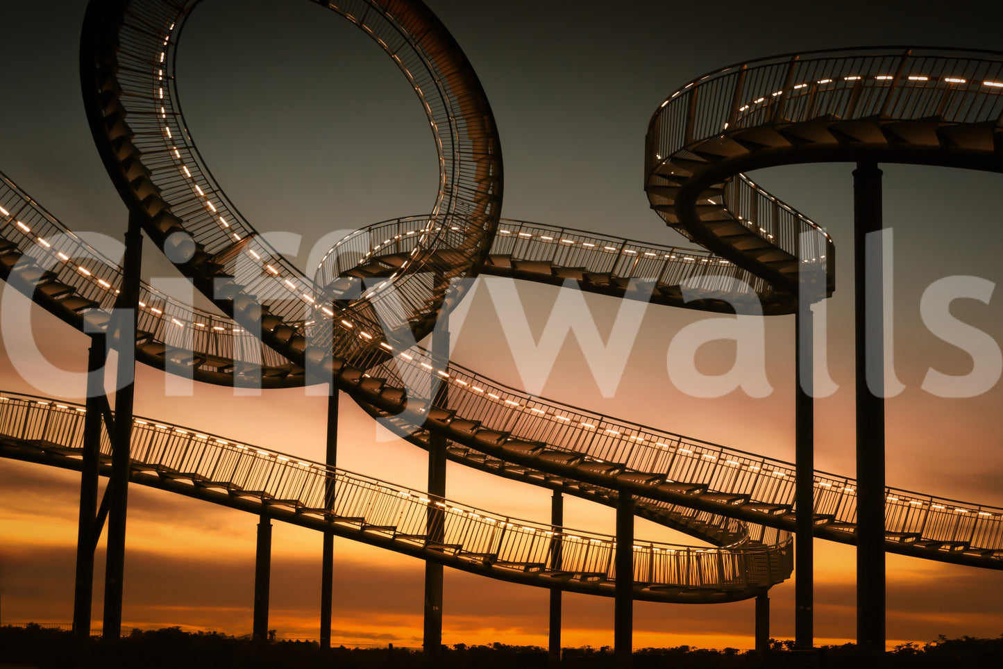 Sky Steps wallpaper mural close-up of the illuminated looping staircase silhouetted against a golden sunset
