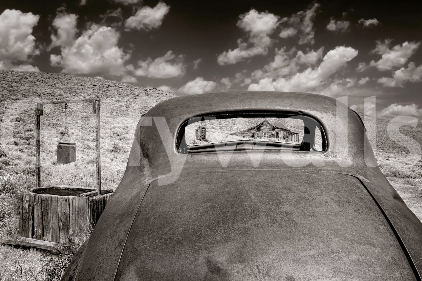 Ghost Town Relic wallpaper mural close-up of a rusted car window framing an abandoned house in the desert
