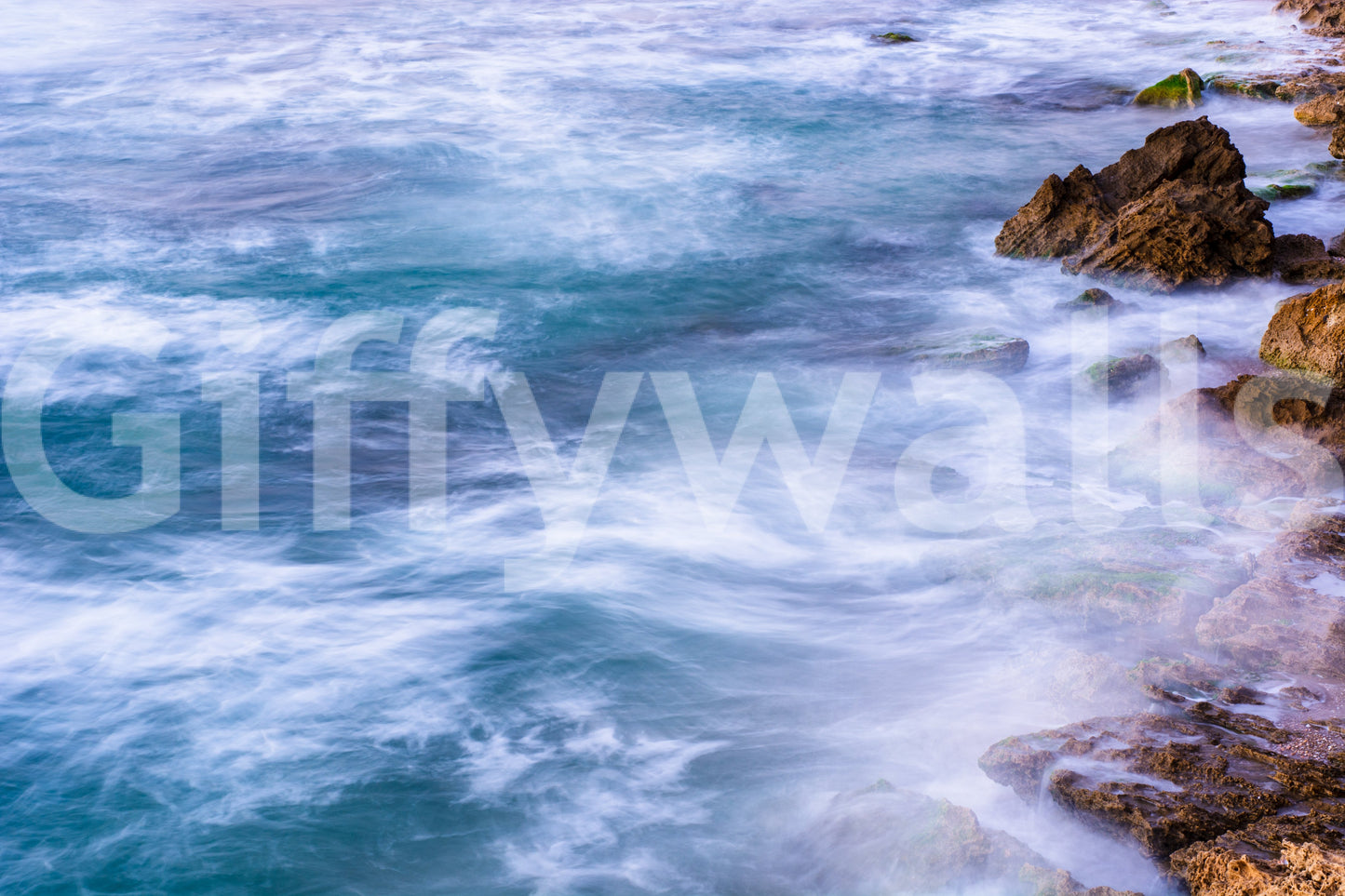 A graceful wave motion wall mural in cool, natural tones.