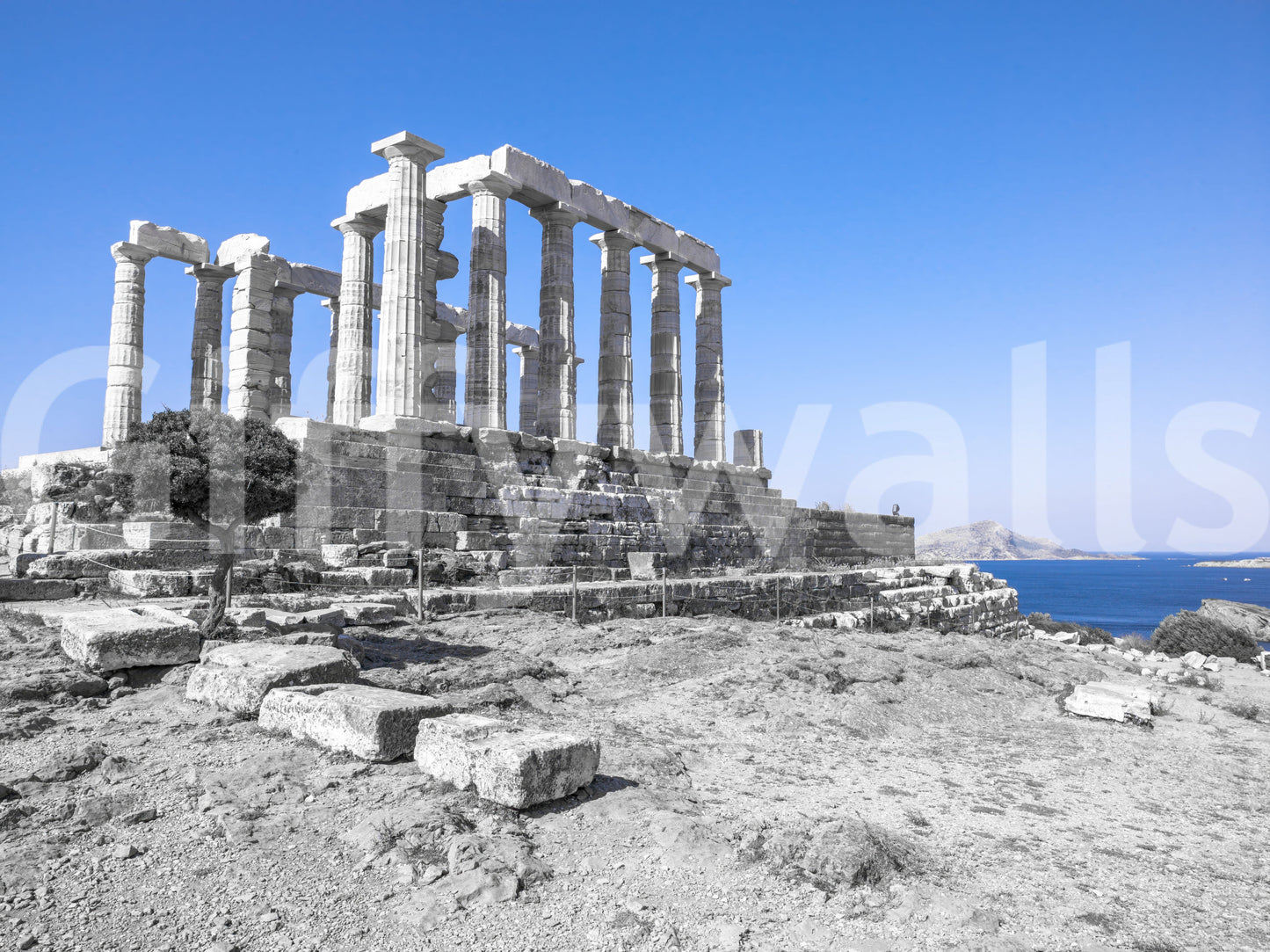 The wallpaper presents the ancient ruins of the Poseidon Temple contrasting beautifully with the vivid blue shoreline.