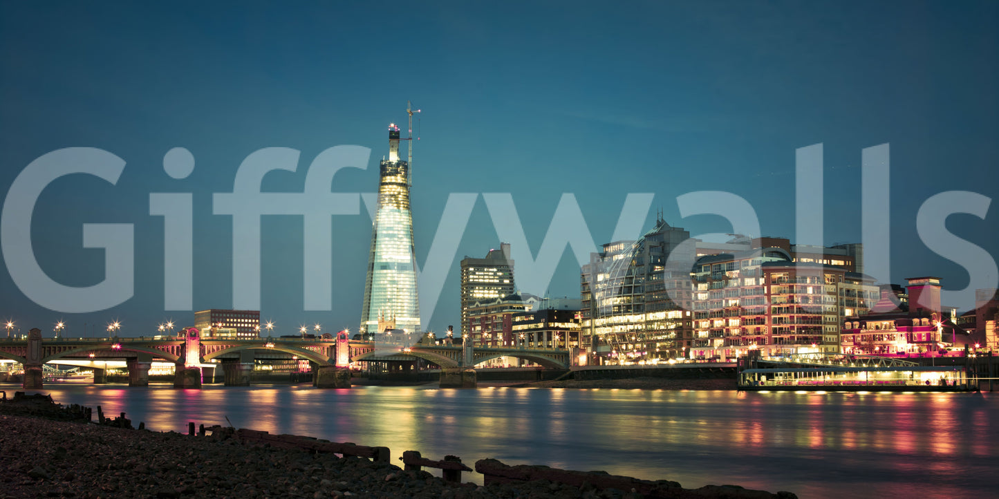 Reflections of building lights spread low on the river in this Skyline wall mural