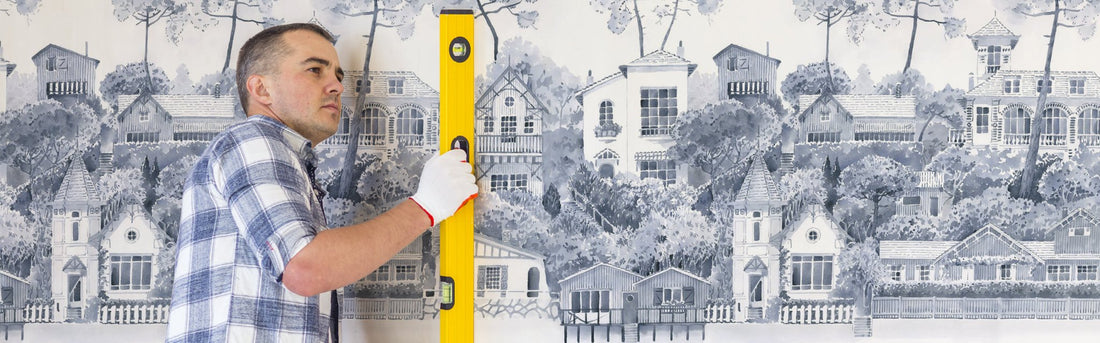 The checklist for wall-planning includes a tape measure and a pencil, demonstrating the process of measuring walls for wallpaper and determining the number of rolls needed.