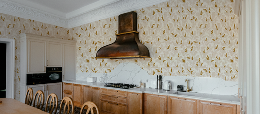 Kitchen wallpaper ideas 2026: a luxury kitchen with gold floral wall coverings.