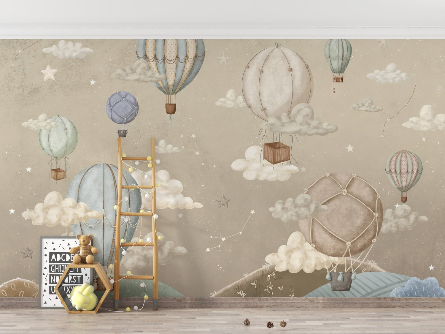 Hot air balloon wallpaper murals above a white cot in a sage nursery