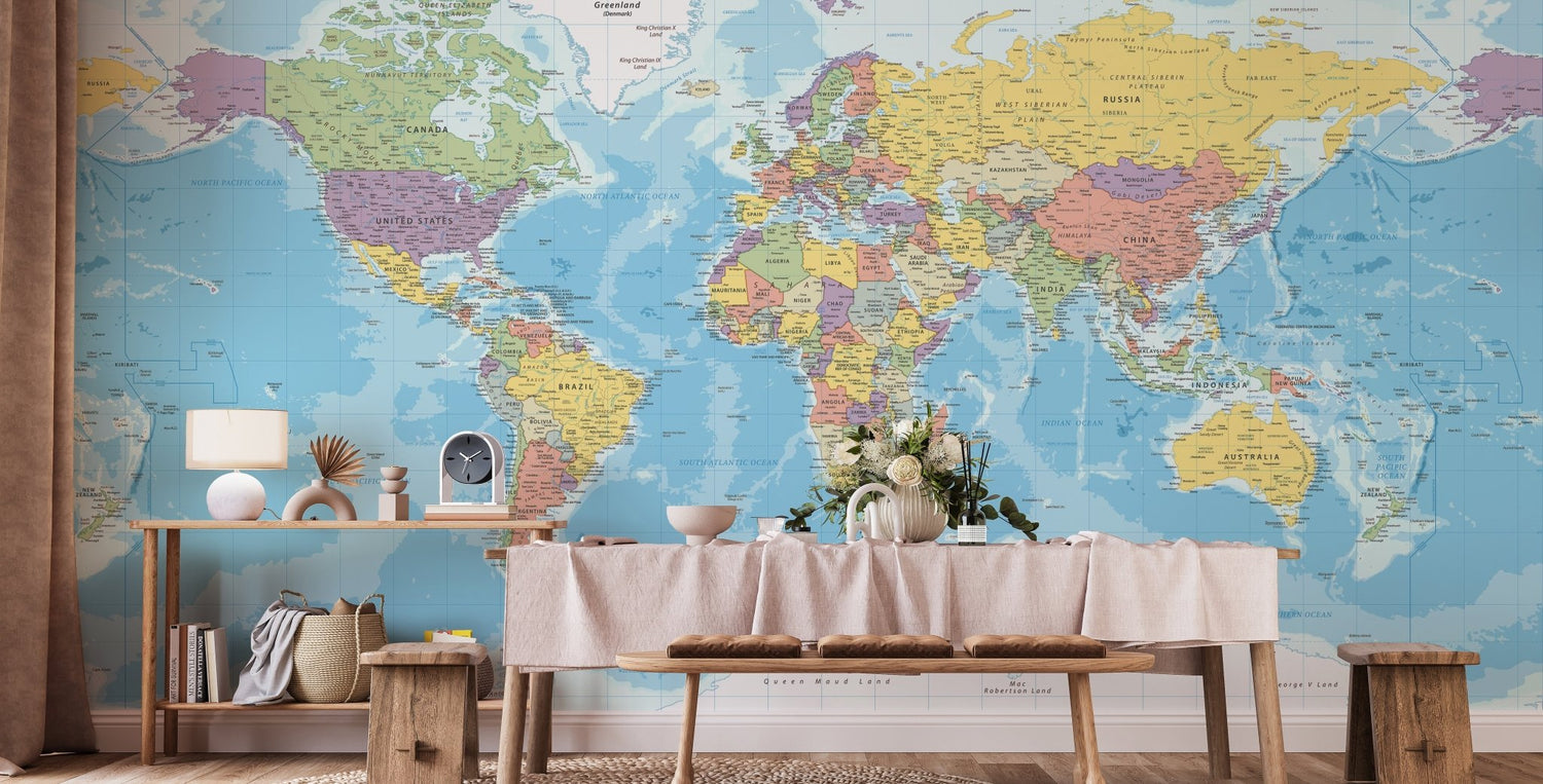 A stylish home office featuring a large, detailed world map wallpaper creating a sophisticated accent wall behind a modern desk.
