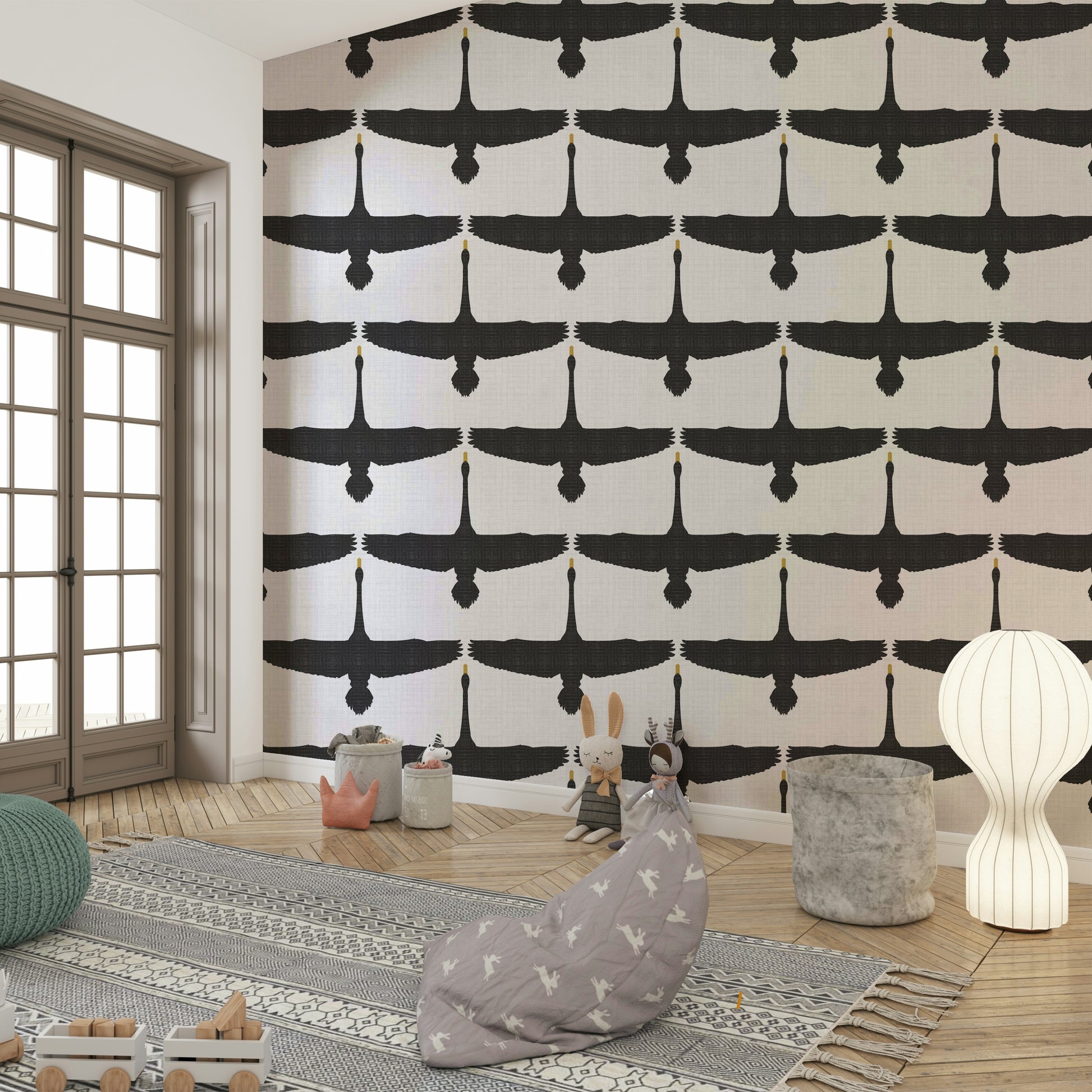 Swan silhouettes soaring across textured gray wallpaper

