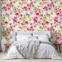 Close-up of pink and yellow blossoms set against a soft green backdrop.

