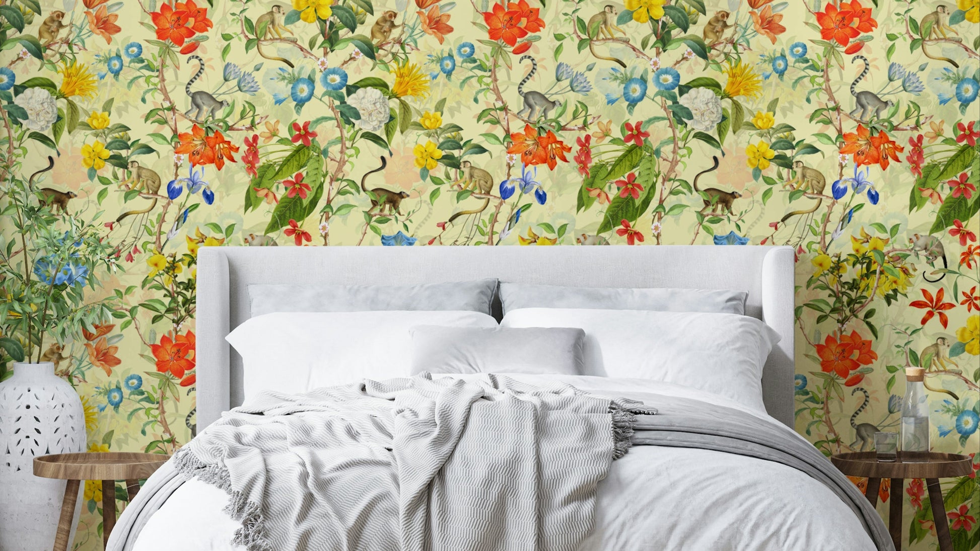 Close-up of playful monkeys and bold tropical flowers in a jungle setting.

