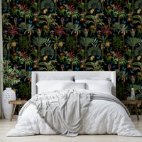 Bold tropical wallpaper with lush plants and rich midnight hues.

