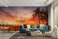 Tranquil beach scene mural with orange and pink sky

