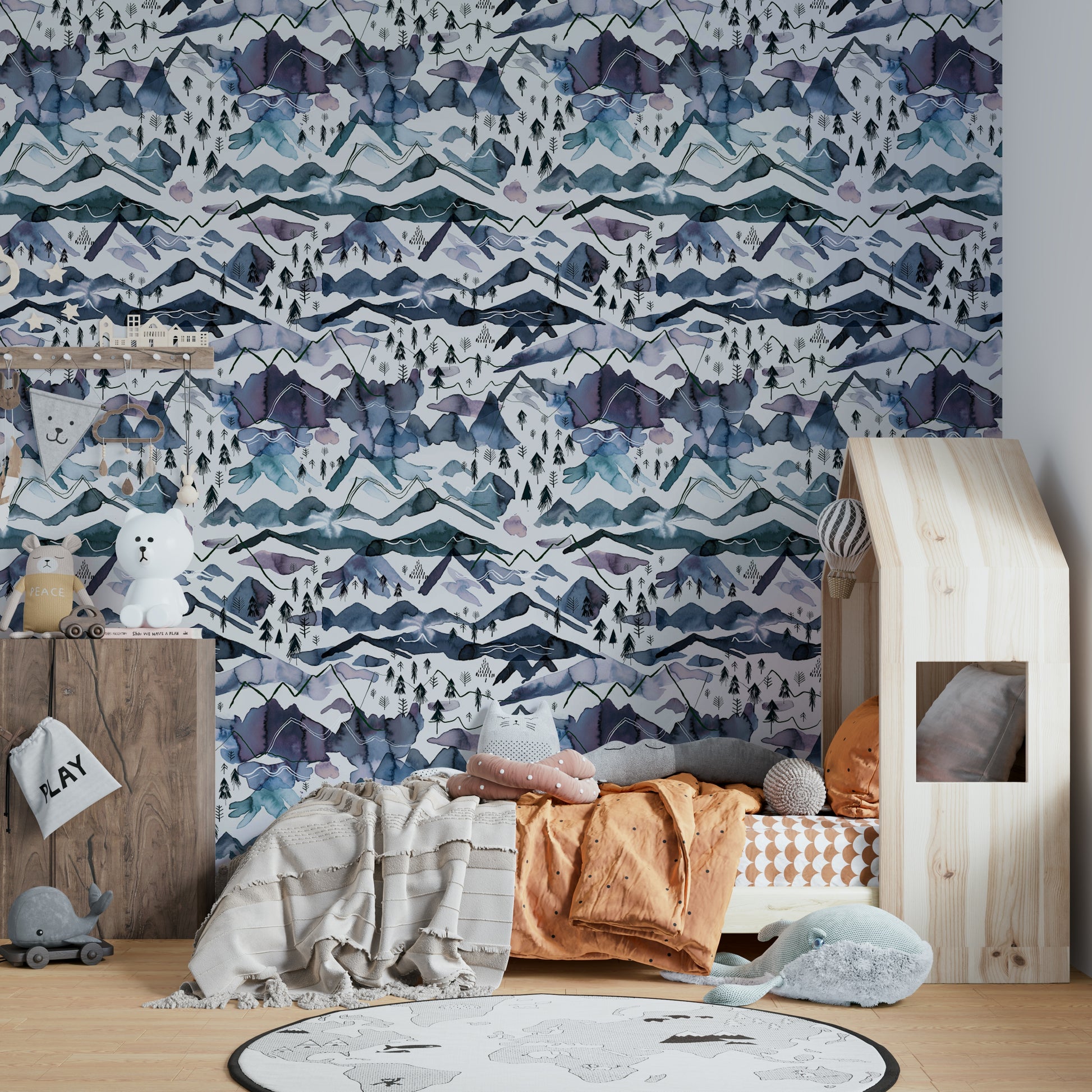 Hand-painted mountain wallpaper in cool blue and dusty mauve.

