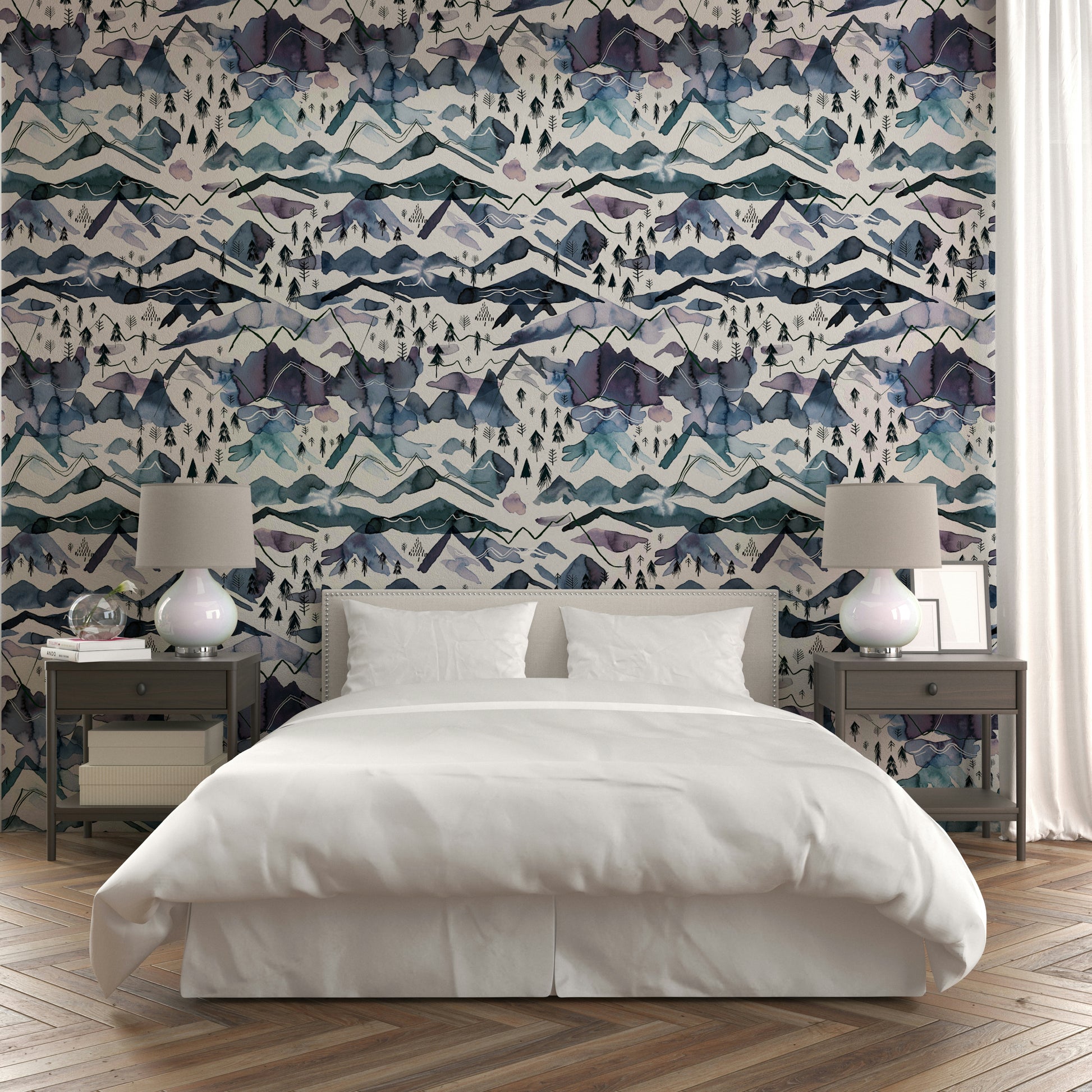 Wallpaper with misty mountain ranges in soft watercolor layers.

