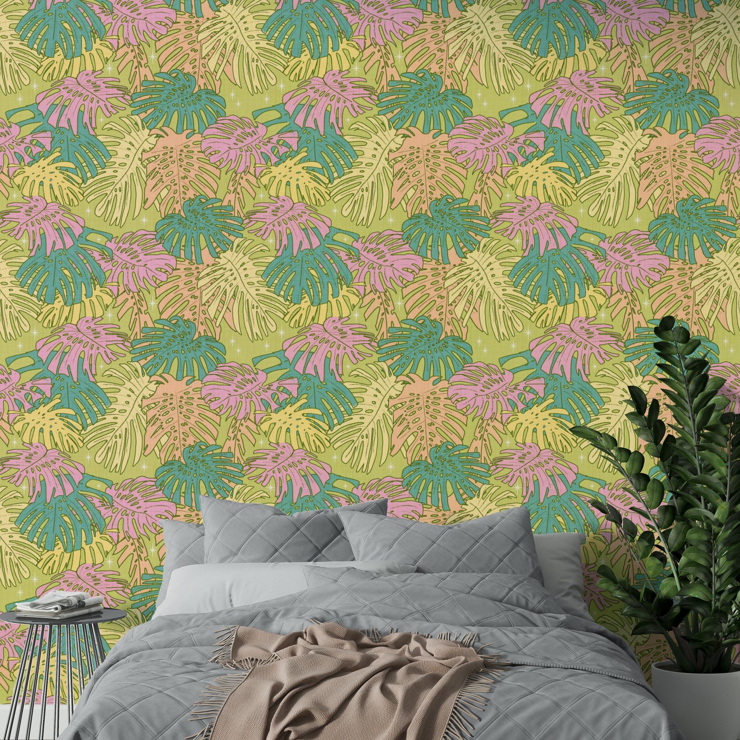 Wallpaper featuring pastel Monstera leaves in avocado green and pink tones.

