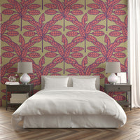 Retro-inspired tropical leaves in vibrant pink and purple on cream wallpaper.

