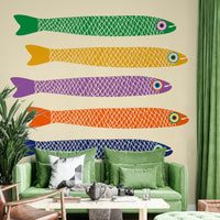 Bright rainbow fish swimming across a soft cream wall mural.

