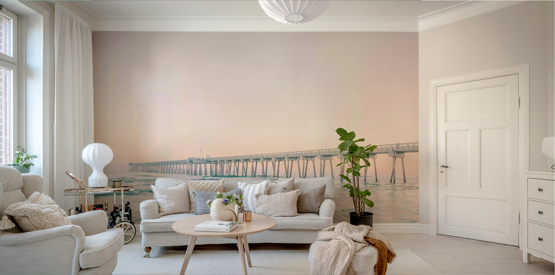 Wall mural featuring pier stretching into sunset


