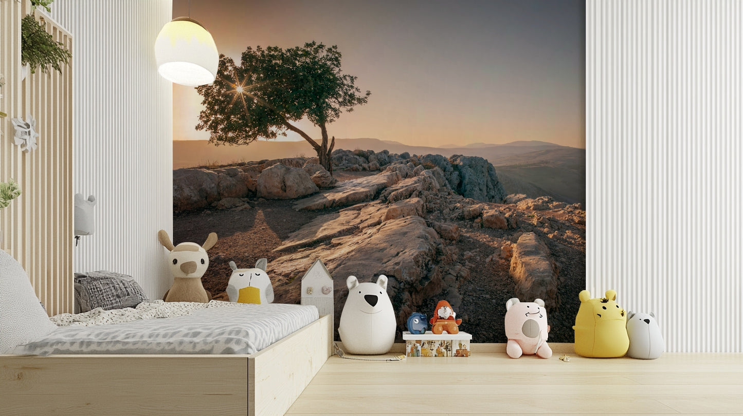 Golden sunset behind a lone tree captured in a wall mural.

