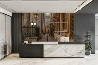 Narrow cobblestone lane in Cambridge with historic architecture mural.

