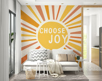 Choose Joy mural with vibrant yellow and orange rays

