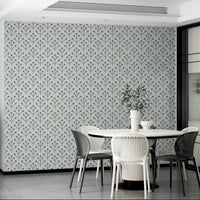 Sage green foliage wallpaper on off-white base

