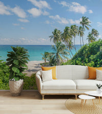 Lush tropical greenery and beach view in wall mural.

