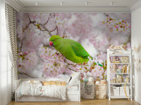 Green parakeet sitting on cherry blossom branch wall mural.

