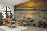 Warm tones sunset mural over beach waves

