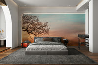 Soft gradient sunset mural with lone tree

