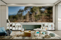 The mural shows vertical lines and soft, blending colors representing trees.

