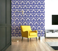 Stylized floral and leaf patterns in Very Peri purple on a wall.

