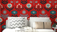 Stylized floral and leaf patterns in blue, navy, indigo, white, and dark red on a wall.

