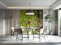 Lush green foliage and sunlight filtering through trees in a wall mural.

