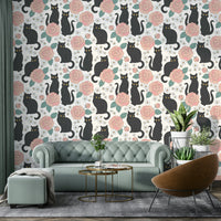 Features elegant black cats interacting with various floral and botanical elements.
