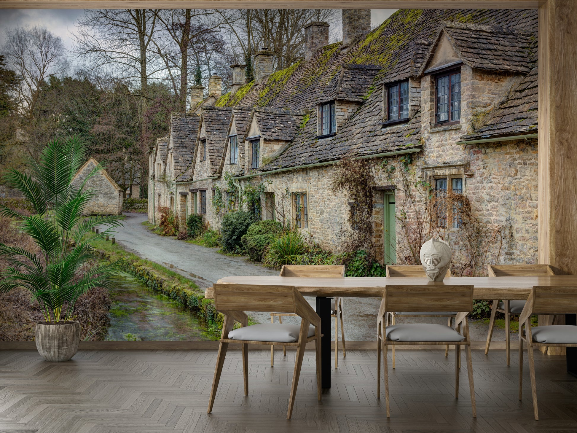 The image shows a row of historic stone cottages with moss-covered slate roofs.

