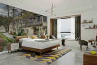 A close-up view of a stone cottage with a small window.

