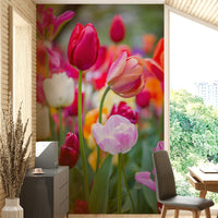 The foreground features several tulips in crisp focus, while the background is a soft blur of color.

