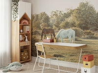 A wall mural showing two horses grazing.

