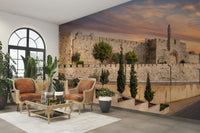 There are green trees and shrubs in the foreground.

