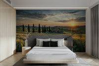 The sky is a mix of warm orange, yellow, and soft pink hues.
